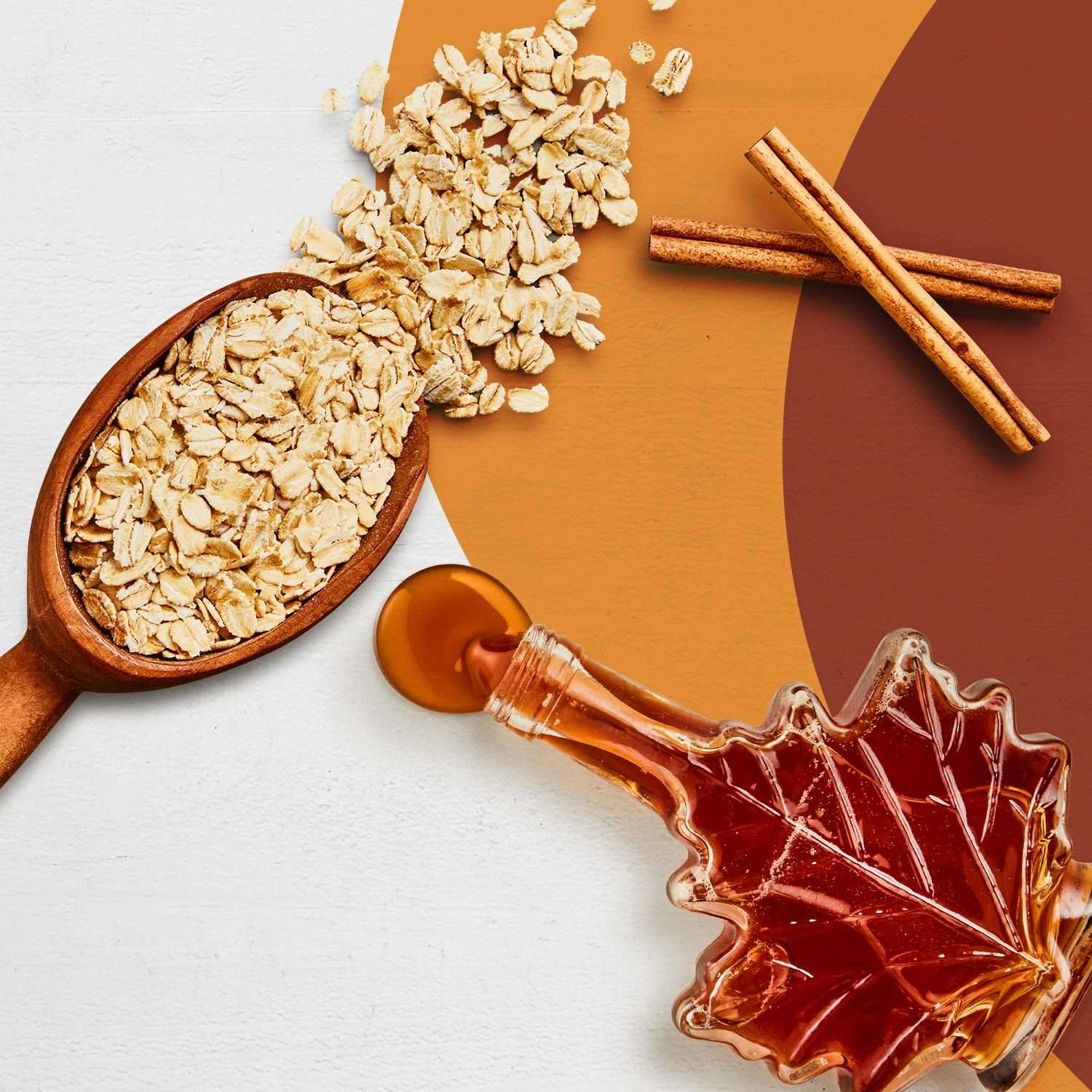 A spoonful of Oats, two cinnamon sticks and maple syrup.