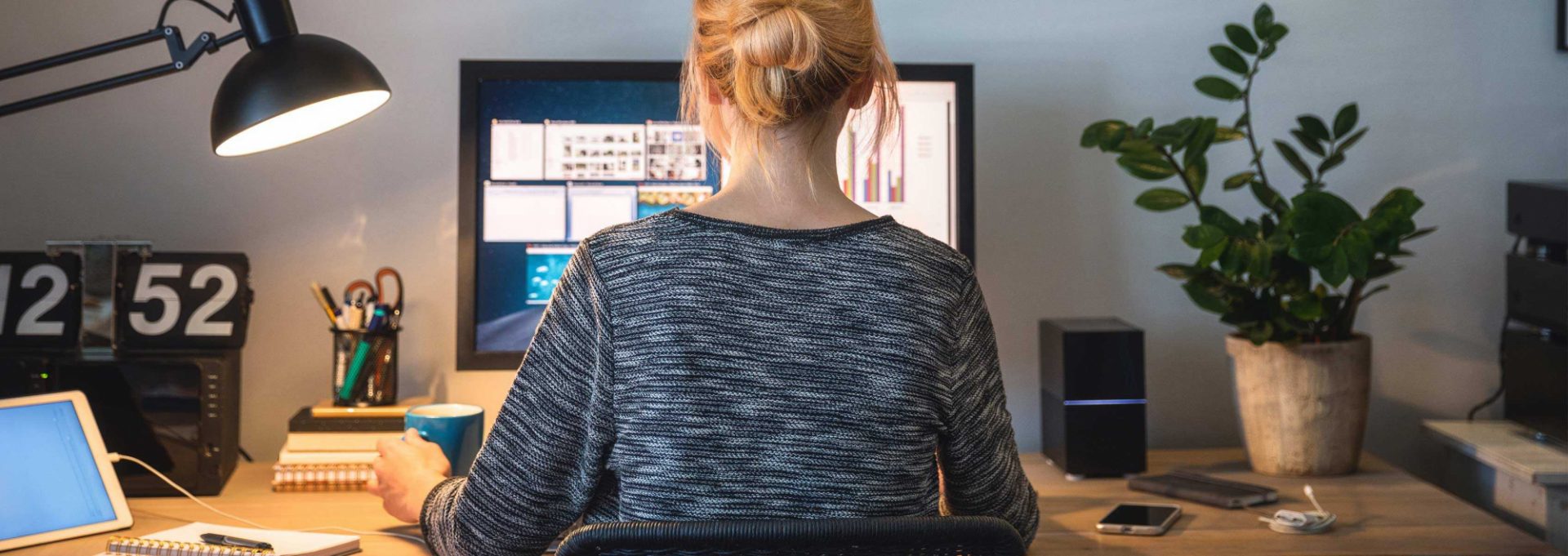 A woman sitting at her desk, working on a computer.