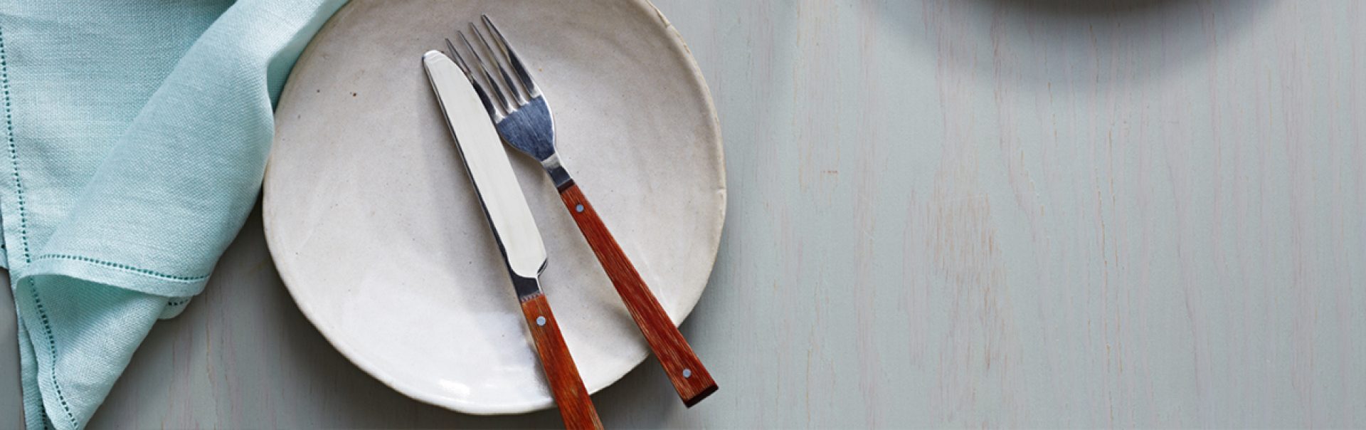 An empty plate with a fork and knife.