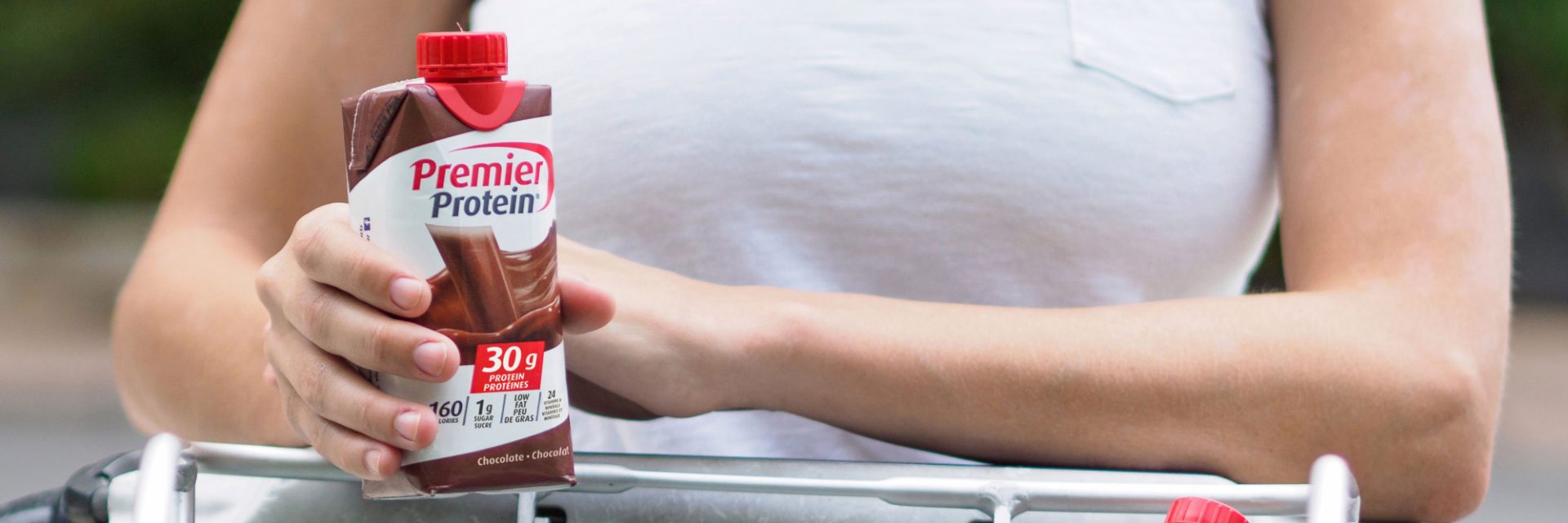 A person enjoying a Canadian Chocolate Premier Protein shake.