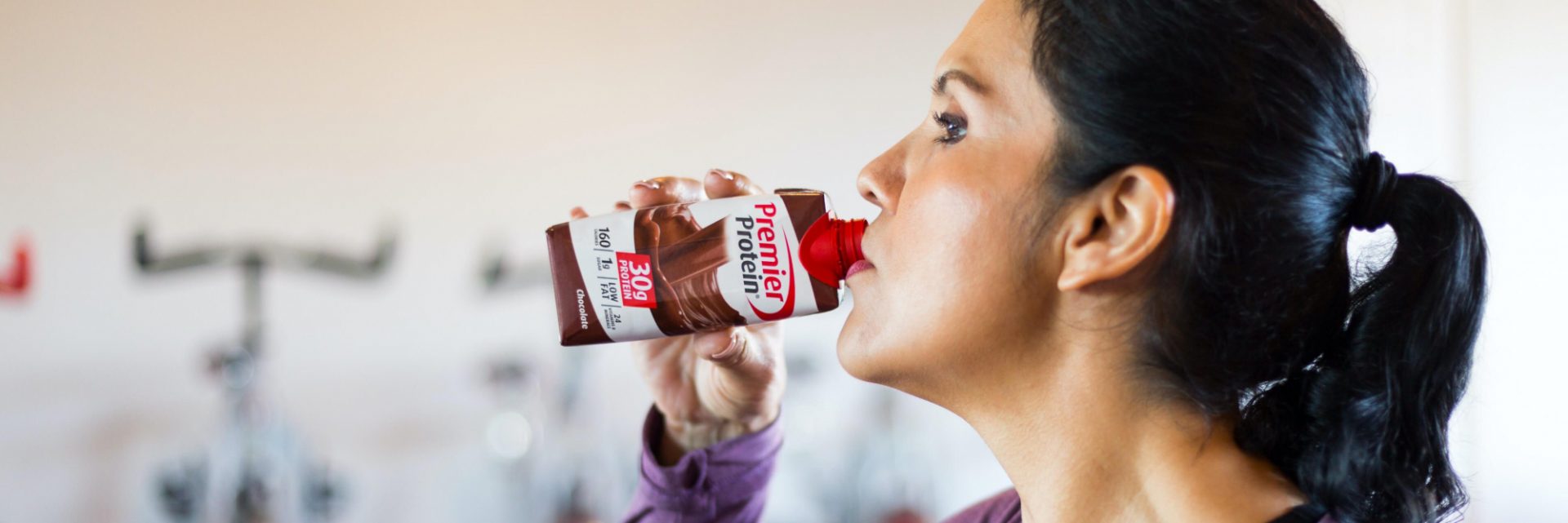 Araceli drinking with a Premier Protein Shake