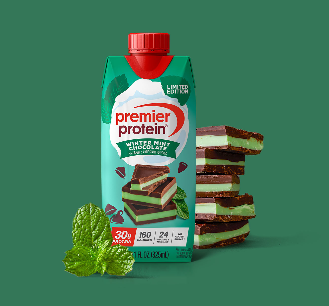 A Premier Protein Winter Mint Chocolate Protein Shake alongside a stack of chocolate mint candy and mint leaves